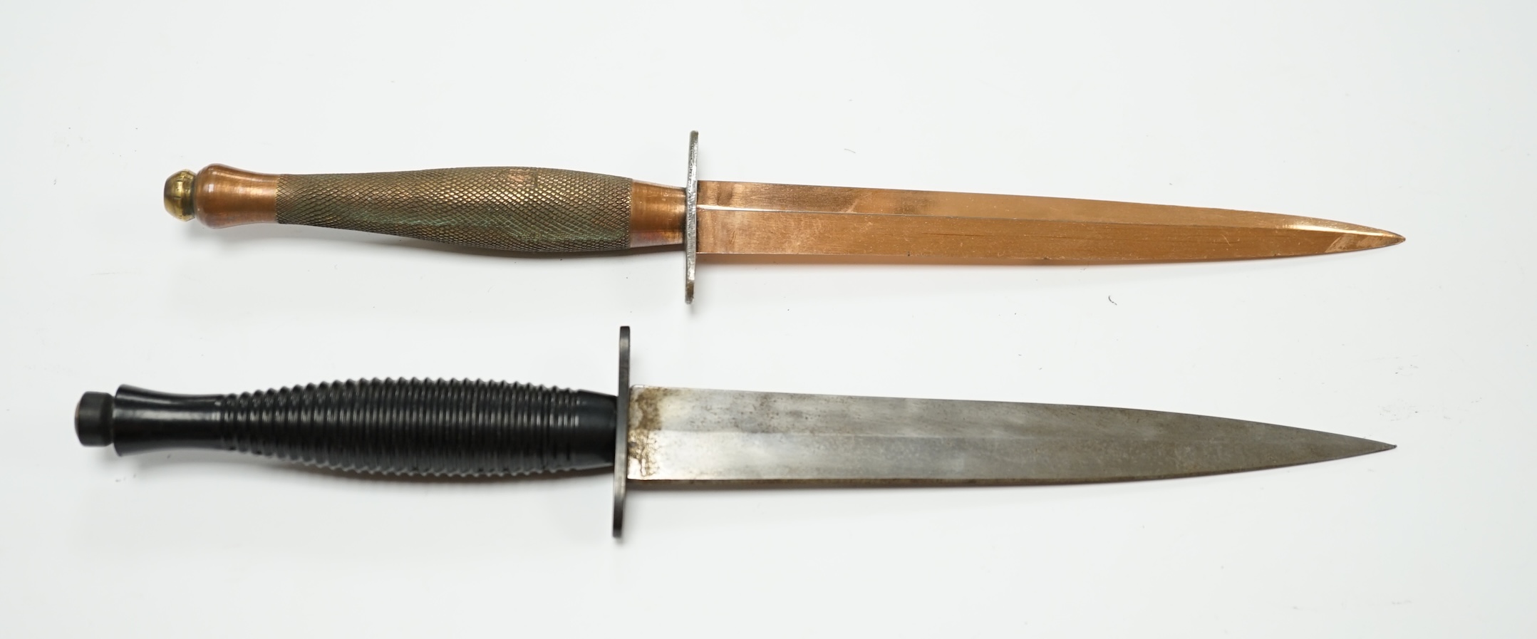 Two Fairburn Sykes style daggers, one copper plated, guard of the other stamped William Rogers, Sheffield, England. Condition - good